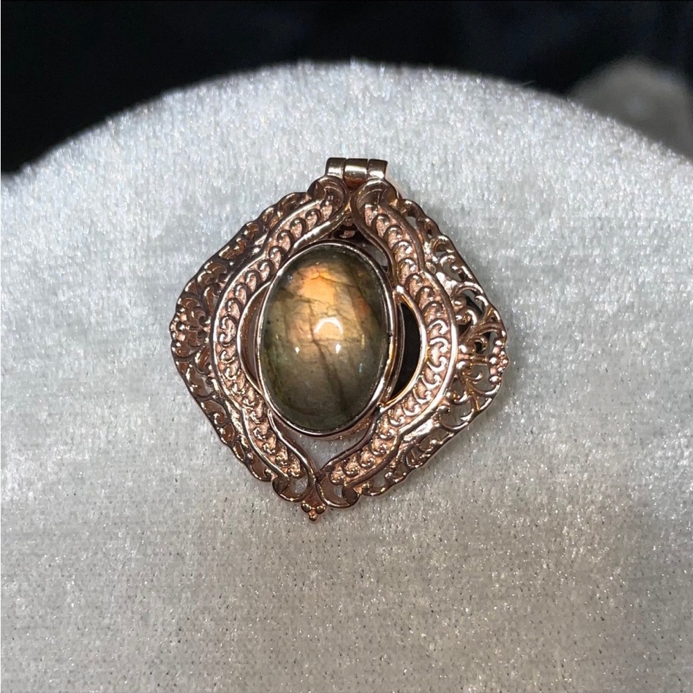 Glowing Laborite pendant surrounded by a beautiful sterling filigree design